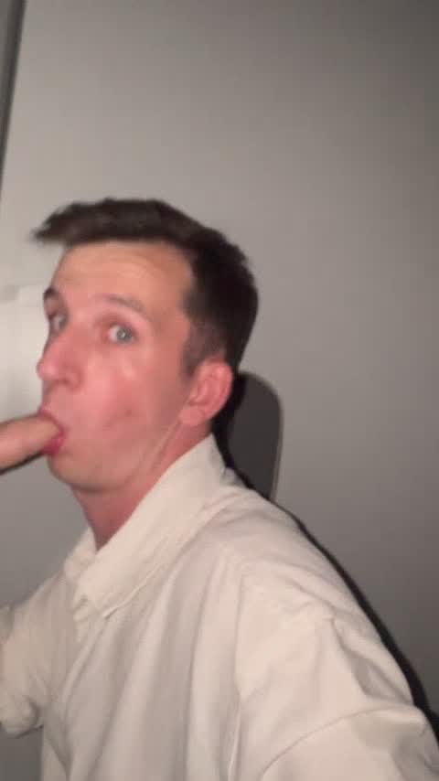 Milking his cock through a glory hole